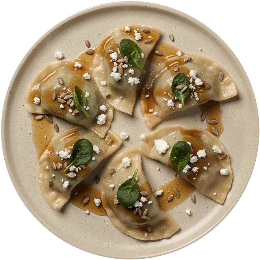 Acht Pierogi mit Spinat und Feta, Sonnenblumenkernen und Fetabröseln